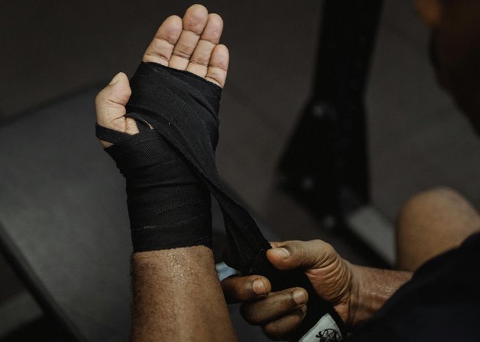 Close up of sports equipment and a man hands preparing for training
